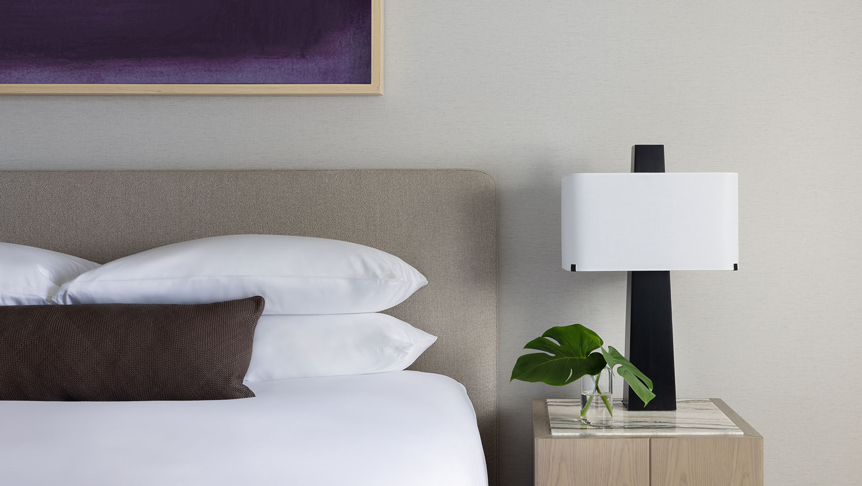 claret king bed with side table and plant